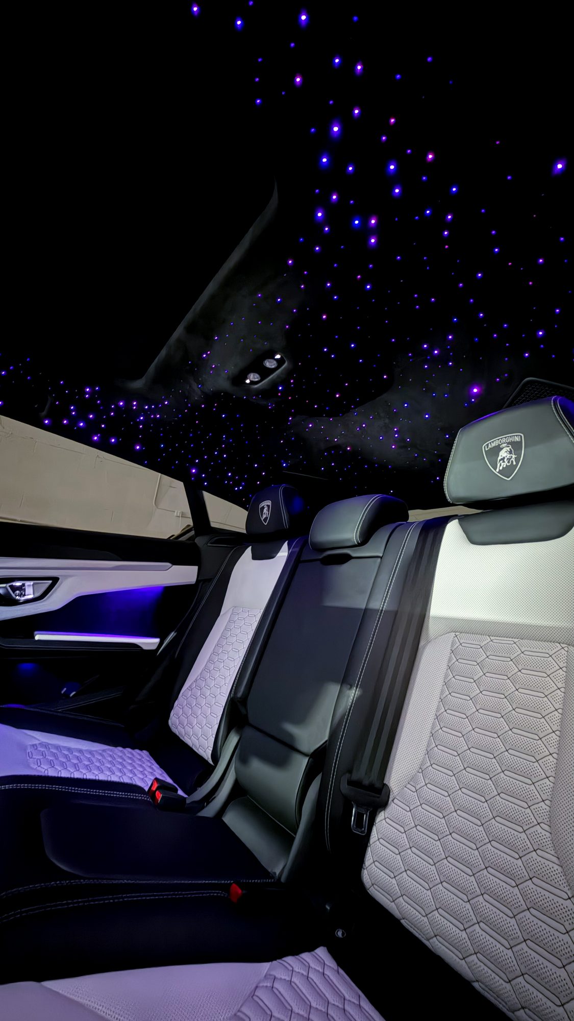 Fiber-optic starlight headliner glowing above a Lamborghini interior, installed by Restyle Miami
